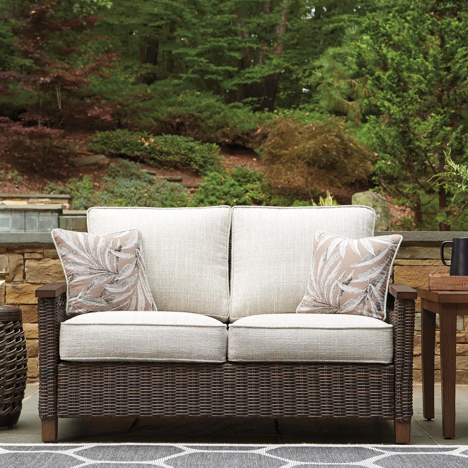 Signature Design by Ashley Paradise Trail Outdoor Loveseat with All Weather Cushions, Medium Brown
